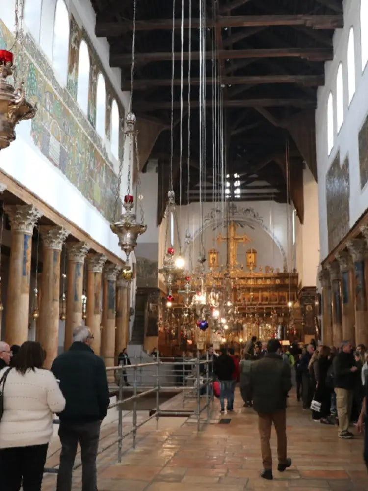 Bethlehem Church Tour Groups Interior of a large cathedral with people walking around, high ceilings, and religious architecture.